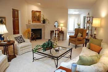 This spacious living room includes a gas fireplace and direct access to the three season room.