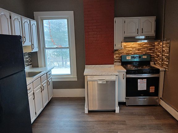 Brand new gas stove, brand new hood, new counter top, freshly upgraded cabinets, new glass and stone backsplash, new luxury vinyl plank flooring