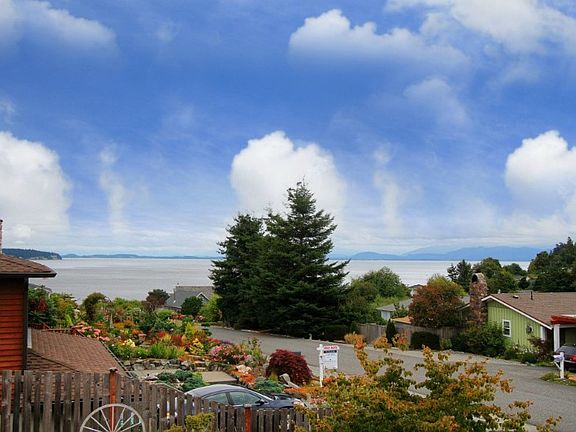 View of the sound and mountains from the view deck. Similar views from the living room, dining area & master bedroom.