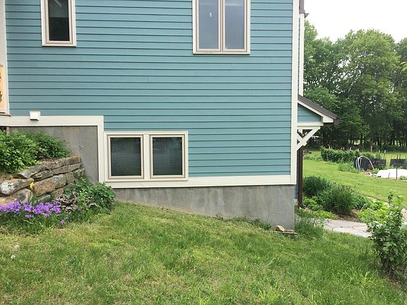 Side view of entrance, yard, and studio windows that face north.
