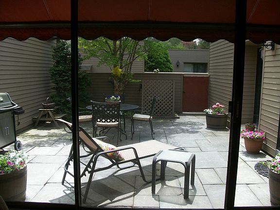 view from living room sliding glass doors out to patio