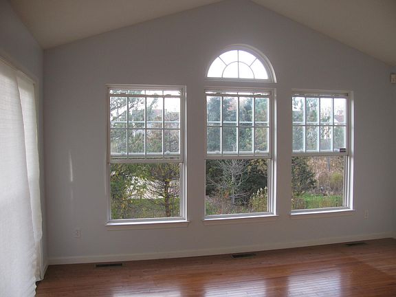 Huge, bright sun room with wood flooring