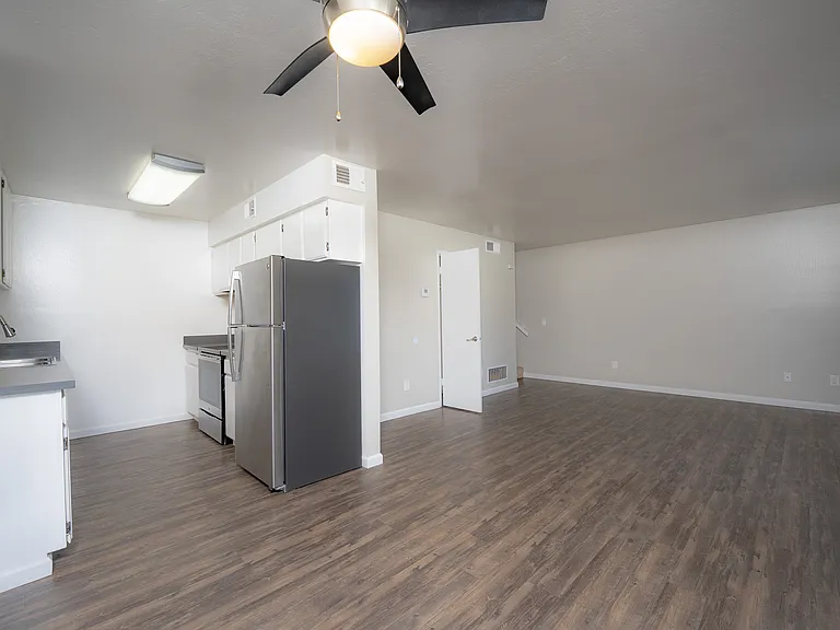 Experience modern living with this open-concept apartment, featuring a stylish kitchen and expansive living space.