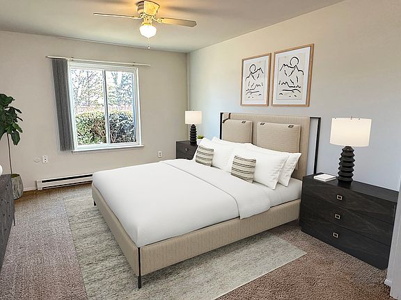 Extra storage space in primary bedroom with plush carpeting and large window.