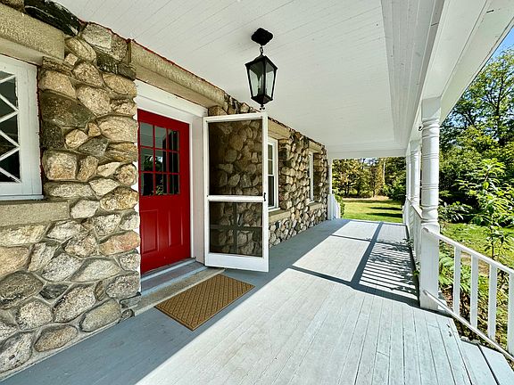 The picturesque front porch brings you to the main entrance with a storm door.