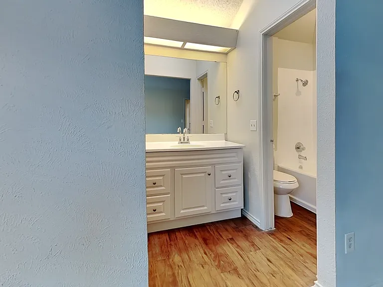 Brightly lit bathroom with neu