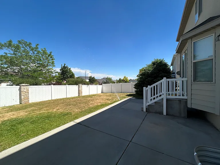 Fenced backyard with patio