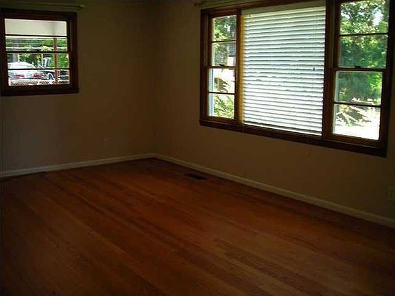 The living room is bright and sunny and has beautiful hardood floors.
