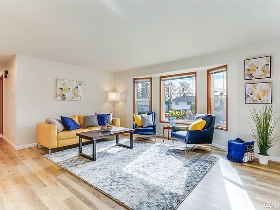 Enter to new luxury vinyl plank floors and large living space with loads of natural light from bay windows.