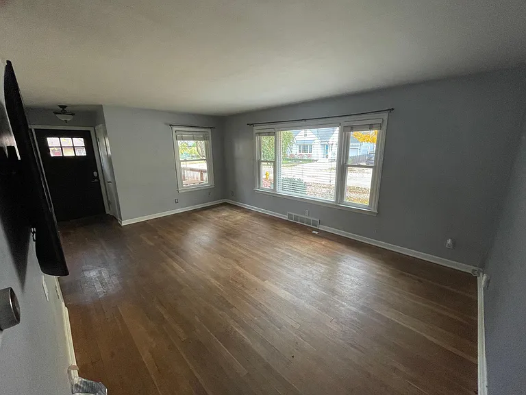 Open living room + Dining with large windows and natural daylight