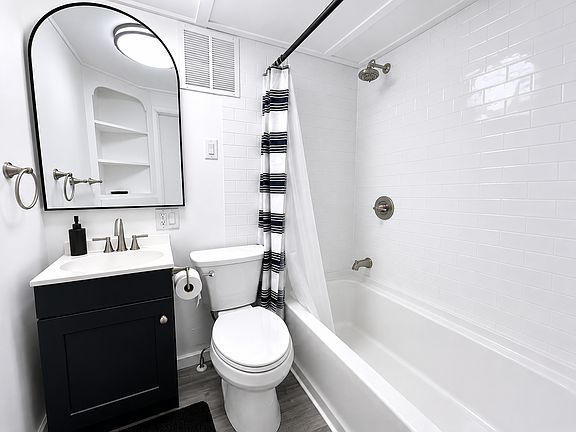 Updated Bathroom Featuring a New Vanity, Tub Surround & Modern Fixtures