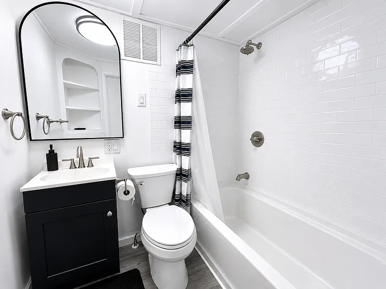 Updated Bathroom Featuring a New Vanity, Tub Surround & Modern Fixtures