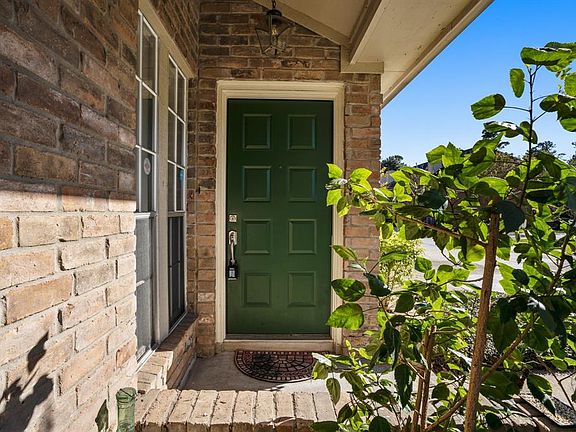 The forest green front door boldly stands out to welcome you home! You won't believe the BEAUTIFUL countertops in this home!
