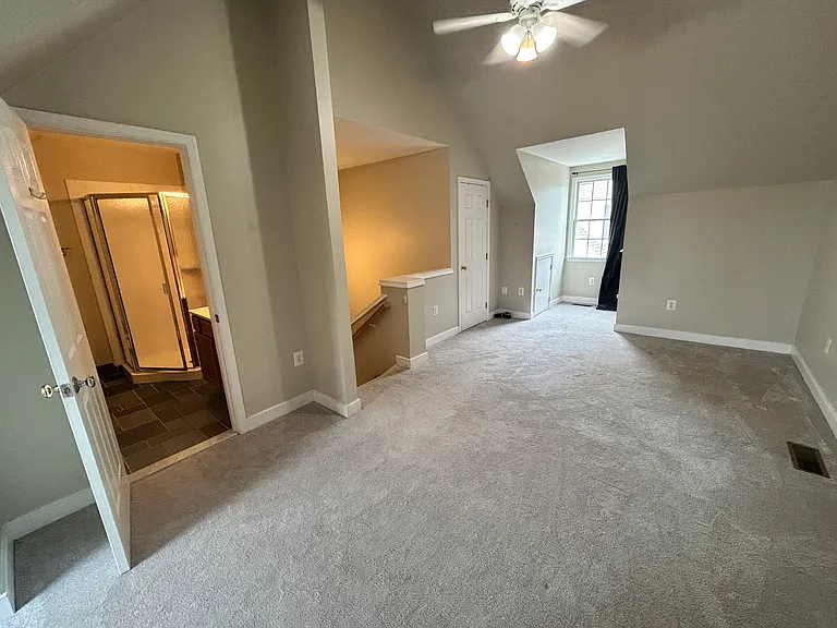 Top floor offers great versatility -- could be large recreation space, master bedroom suite with space for two home offices, one large walk-in closet, plus three huge storage spaces, fan and attached bath. Carpet is 2 years old. Door on second floor.