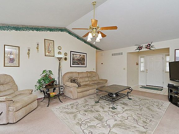 Tiled entry way welcomes guests into large living room