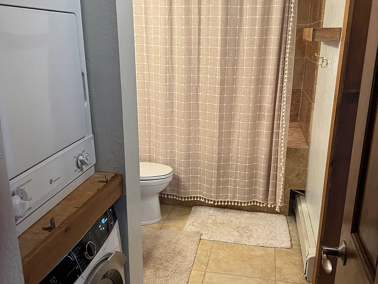 Bathroom 1 shown with laundry area