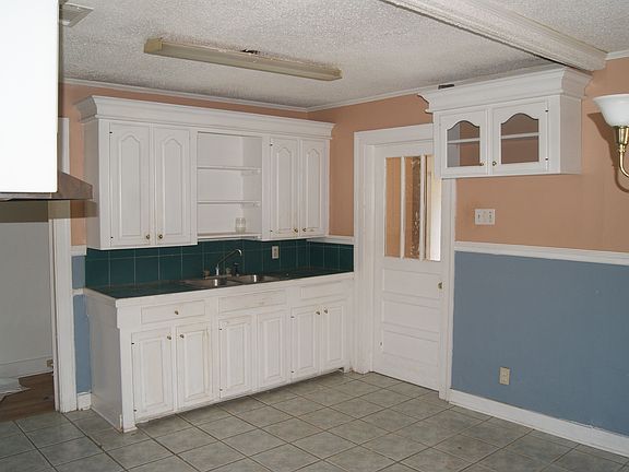 Main kitchen view showing cabinets, countertops, and appliances layout.