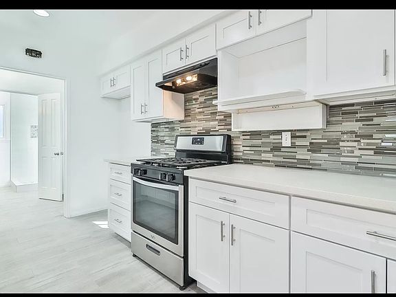 New kitchen cabinets, quartz counter tops and tile floor