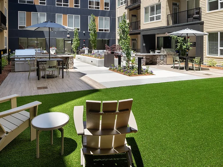 Courtyard #2 gathering space with lounge seating and bbq grills