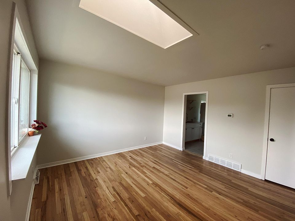 The living room has a large front window and skylight to let in natural light and views of downtown all day.