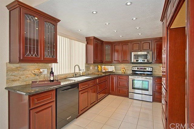 Lovely, Renovated Kitchen....Granite Countertops & Stone backsplash, Raised Panel Cherry Stained Cabinets, Recessed Lighting, Un