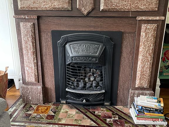 Gorgeous period fireplace with insert and original hearth tile.