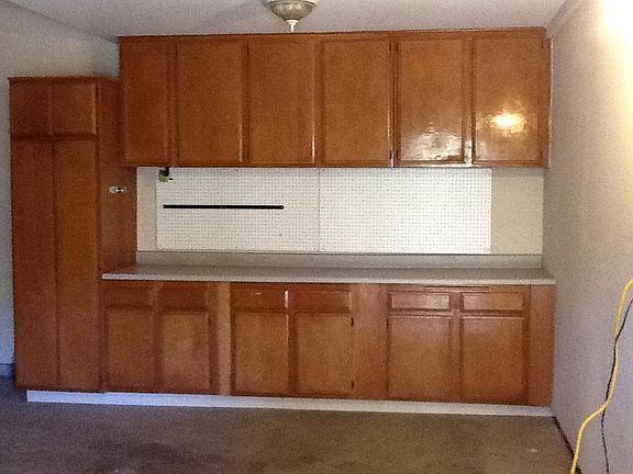 Finished garage with cabinetry.