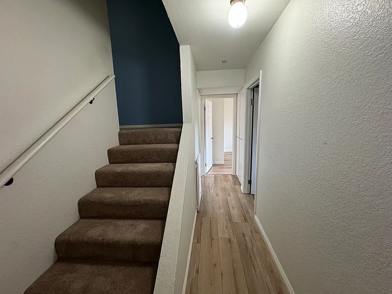 Stairs and hallway to downstairs bedrooms