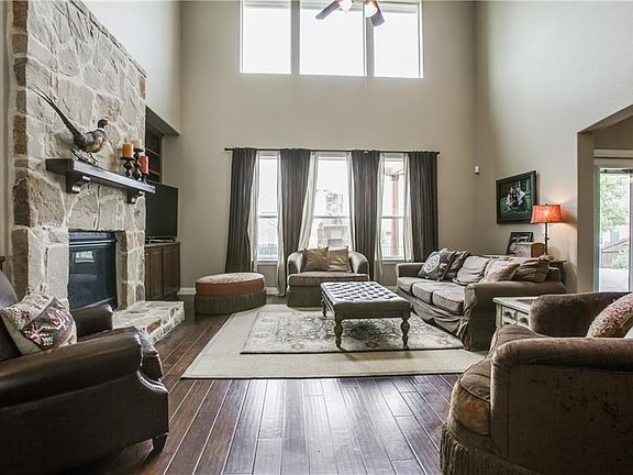 Soaring ceiling in living area. Stone fireplace.