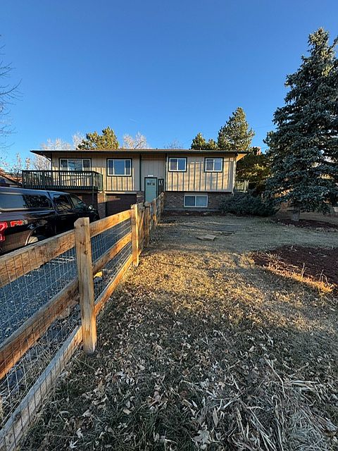 Front of house showing 4 car+ driveway and fenced in yard
