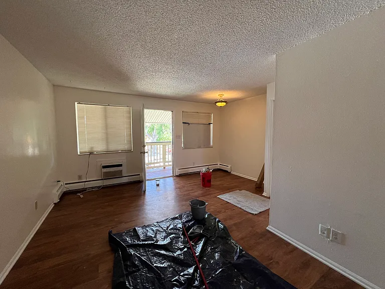 Front door, living room and breakfast nook. Still being renovated. Plank flooring