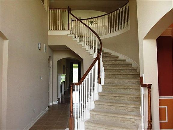 Entry is grand with soaring ceilings & elegant staircase