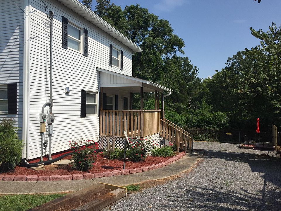 Private covered porch, umbrella table and chairs and pad for