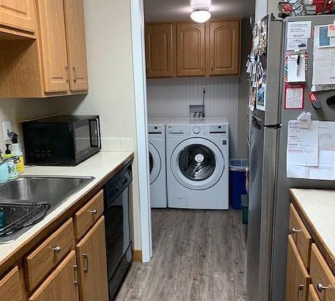 Kitchen. 3 Year old fridge. Leading to laundry room and back door.