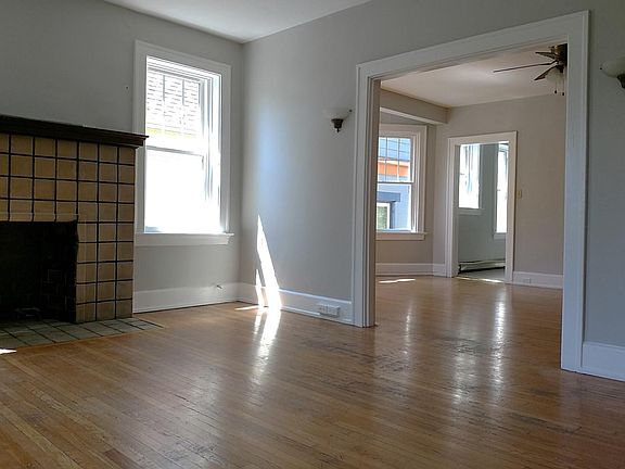 Two spacious living areas with hardwood floors! This one has a decorative (inoperable) fireplace and french doors out to the large covered balcony.