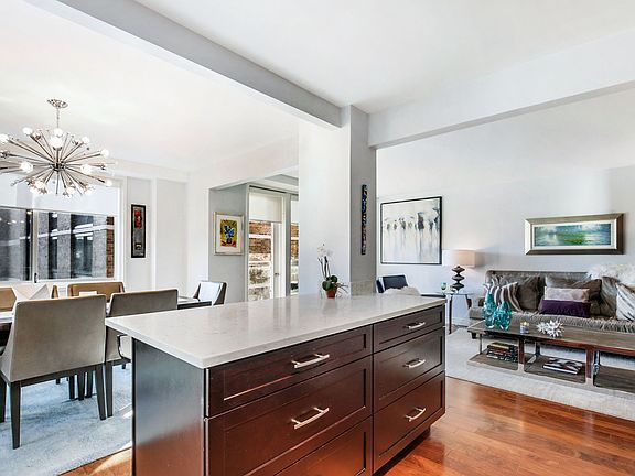 The dining and living rooms are spacious, with windows galore and a gleaming glass door that opens to a private terrace