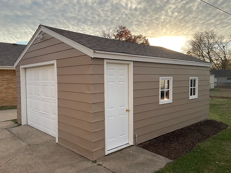 Side entrance of garage, with new entry door
