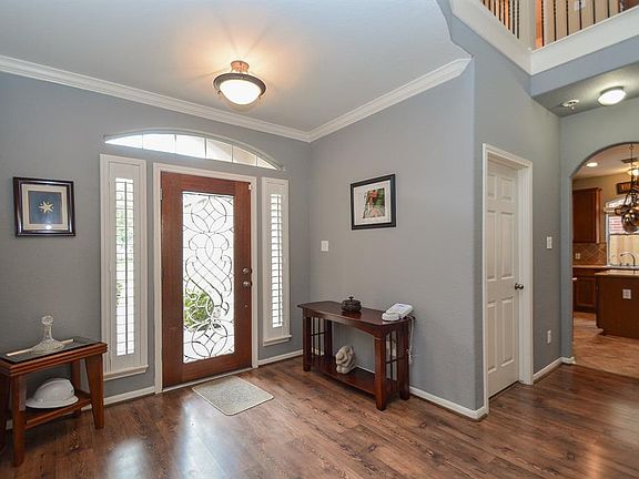 You will enter the home through the full leaded glass front door with the transom window above and two vertical windows with plantation shutters into the foyer.