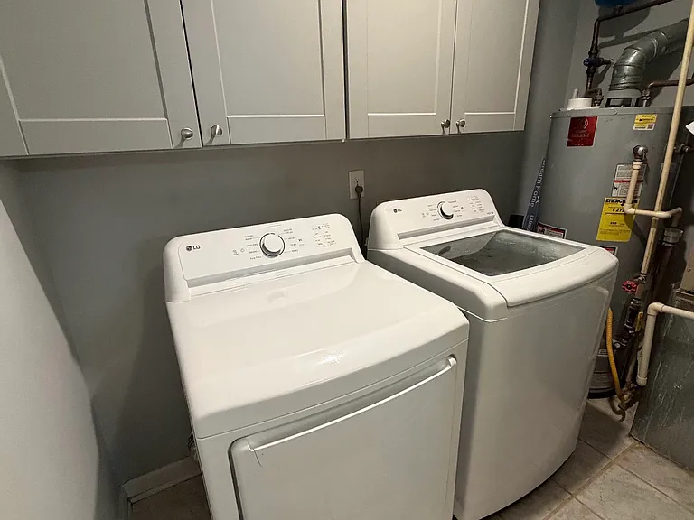 Laundry room with new washer and dryer