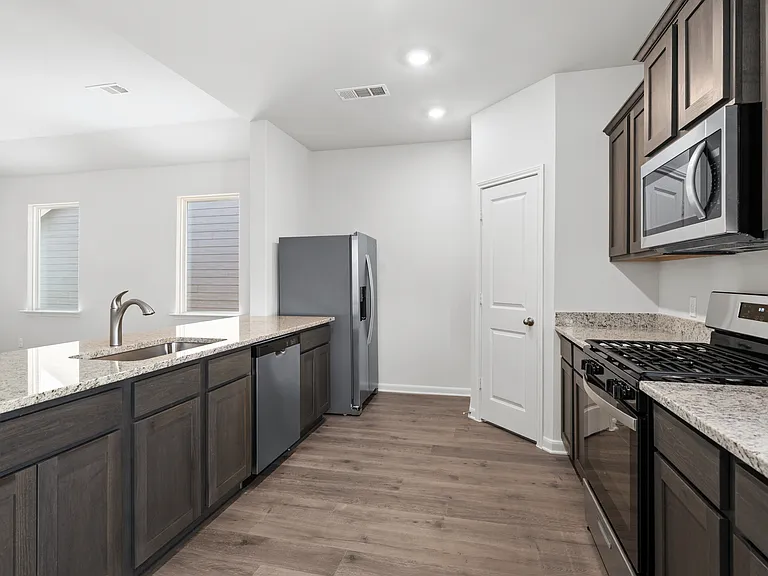 The kitchen has stainless steel appliances.