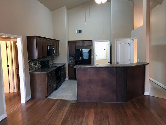 Beautiful vaulted ceilings with kitchen and bar open to the