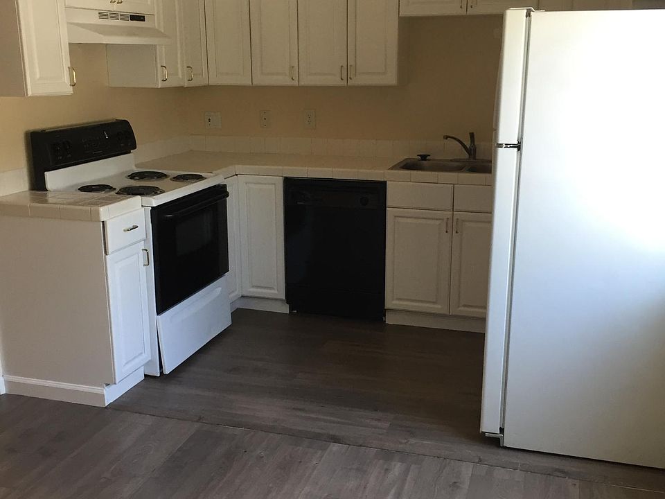Kitchen with hard surfaces on the floor throughout the apart