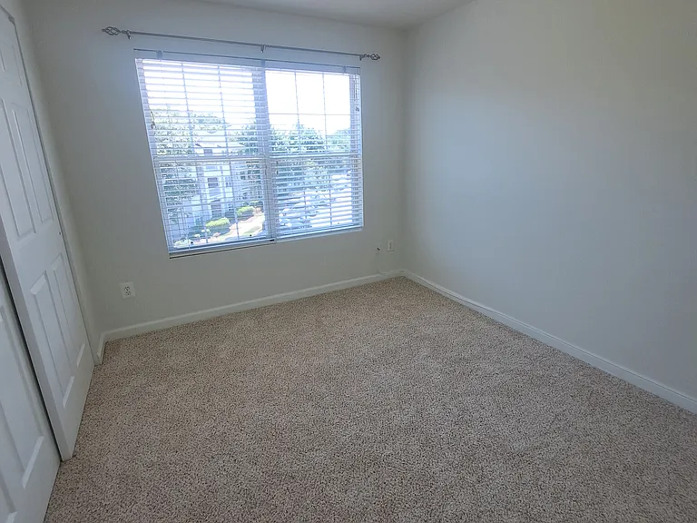View of the second bedroom with large closet on the right