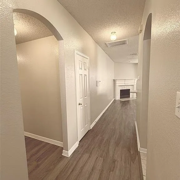 HALLWAY LEADING TO THE DEN WHICH IS OPEN TO THE KITCHEN.
