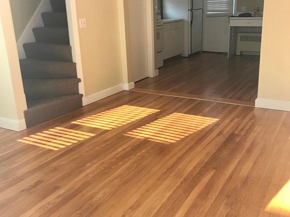 Living room with closet open to kitchen with door to the large back deck.