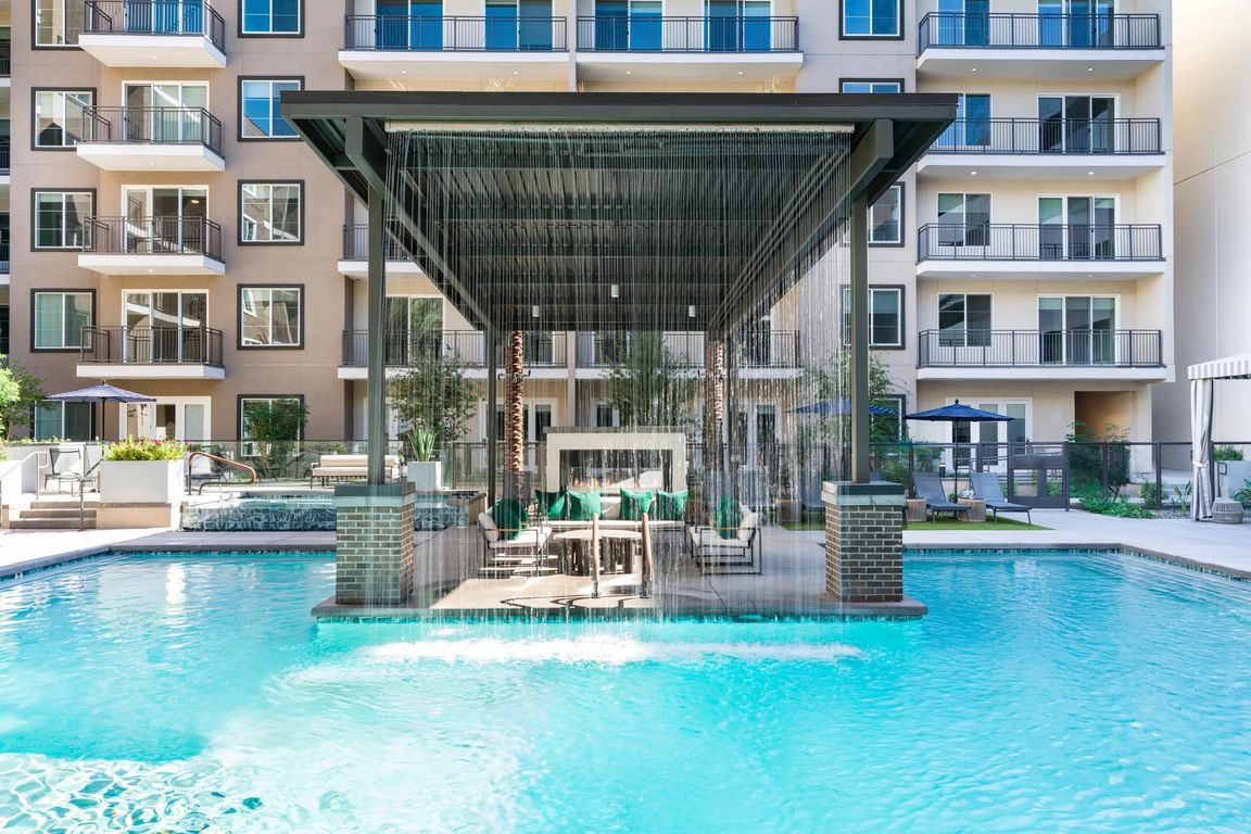 Our resort-inspired pool features a dramatic rain curtain and shaded seating area, perfect for relaxing or socializing in style.