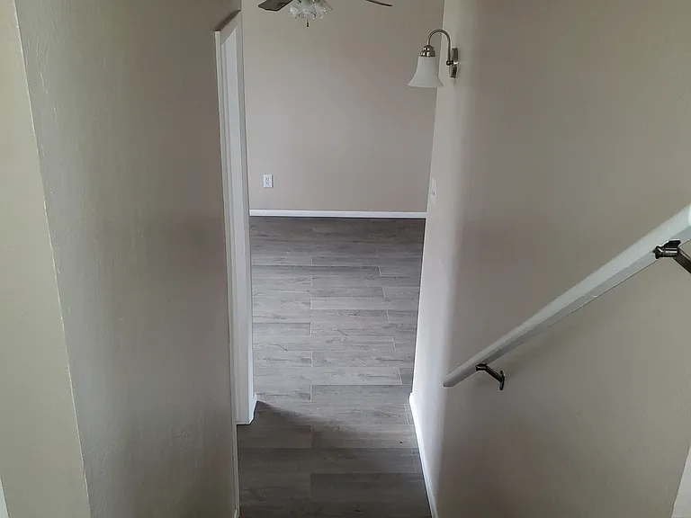 Recent photo of new luxury vinyl flooring - view from kitchen to lower level living room area.
