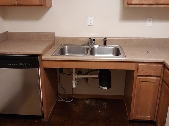 This unit has open space under the kitchen sink for easier accessibility.