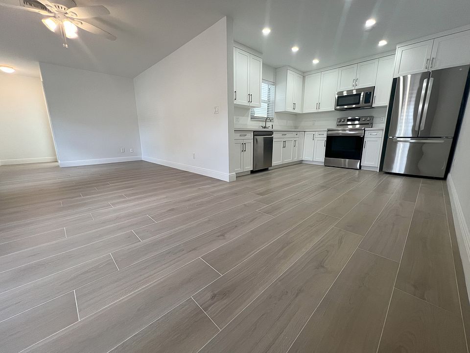 Kitchen open to Family Room. Brand new porcelain tiled floors, recessed LED lighting, LG appliances.