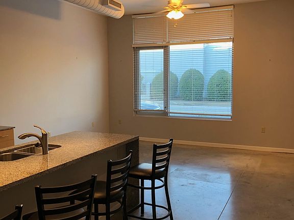 Spacious living area off of kitchen with large picture window for added natural light.